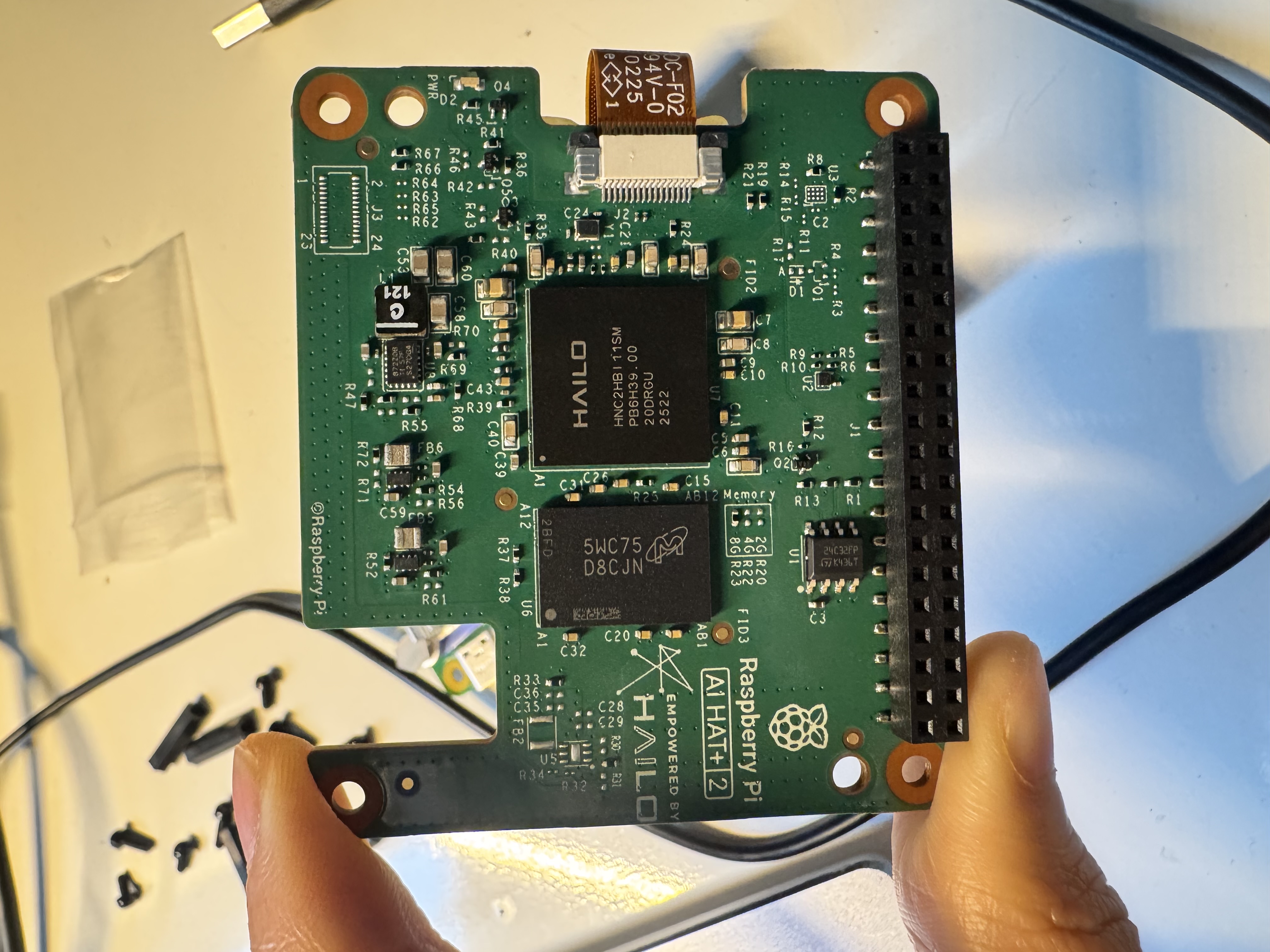 Underside of the AI HAT+ 2, showing the Hailo-10H chip and PCIe flex connector